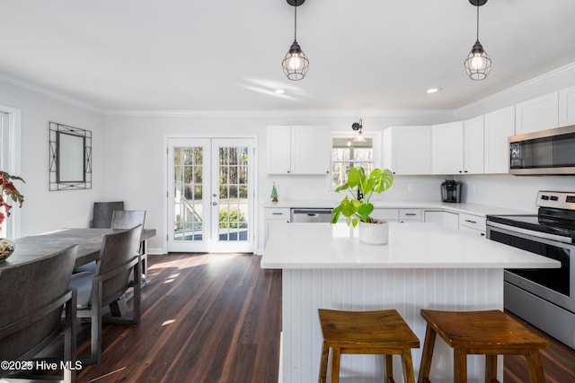 kitchen featuring decorative light fixtures, white cabinetry, appliances with stainless steel finishes, and french doors