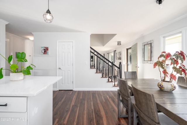 dining room featuring dark hardwood / wood-style floors and crown molding