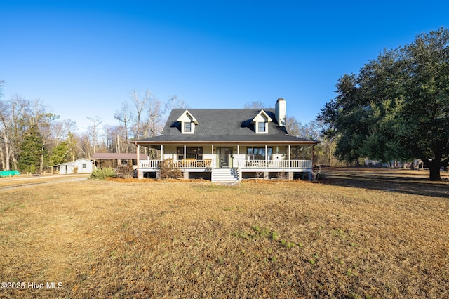 view of front of house with covered porch and a front lawn