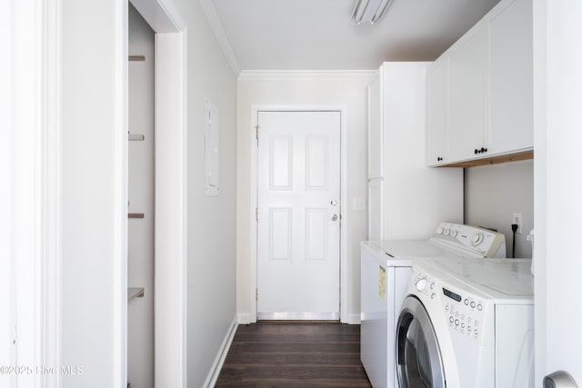 laundry area with cabinets, dark wood-type flooring, washer and clothes dryer, and ornamental molding