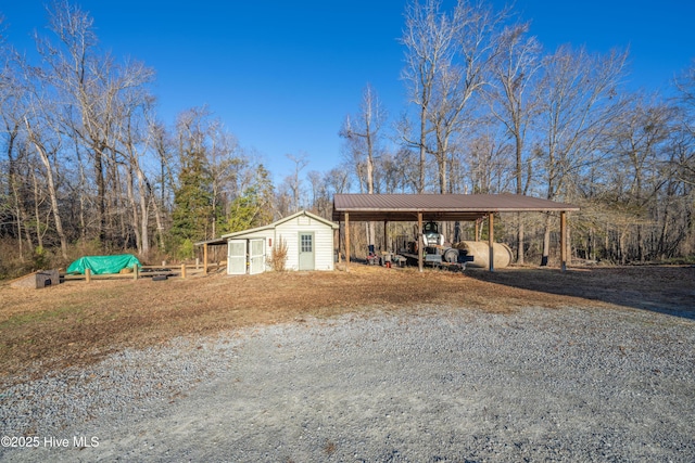 view of front facade featuring an outbuilding and a carport