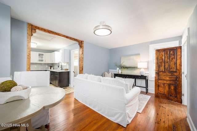 living room with hardwood / wood-style floors and sink