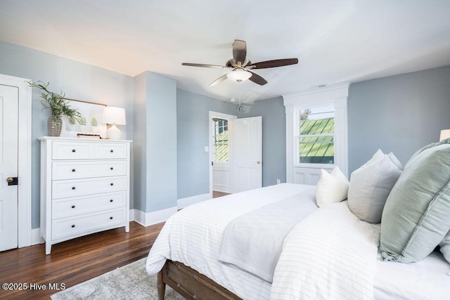 bedroom with dark hardwood / wood-style floors and ceiling fan