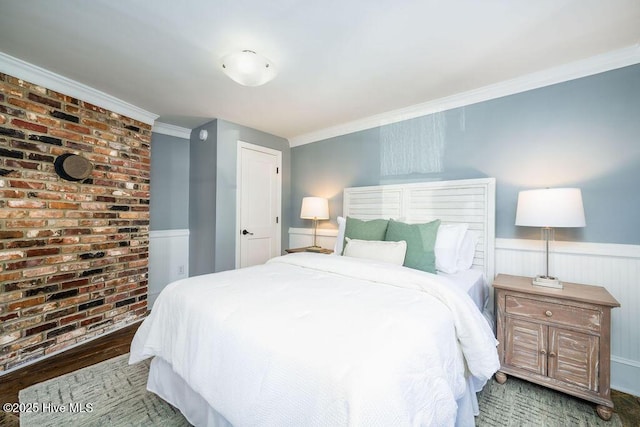 bedroom with wood-type flooring and ornamental molding