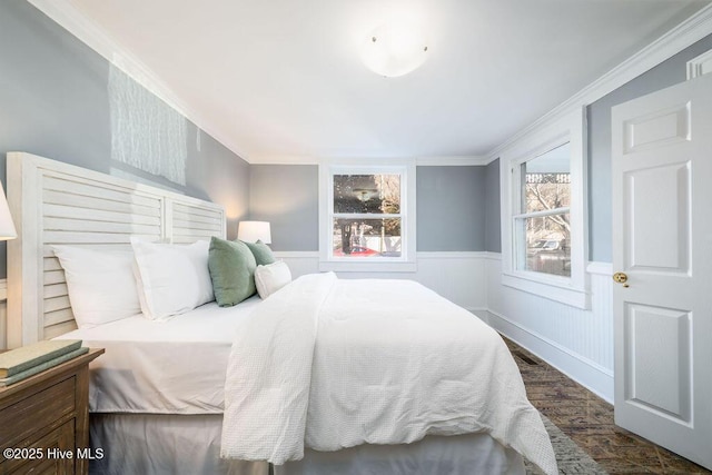 bedroom with dark hardwood / wood-style flooring and crown molding