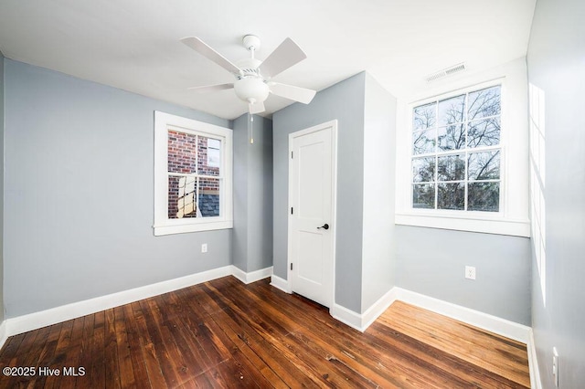 unfurnished bedroom featuring ceiling fan and dark hardwood / wood-style flooring