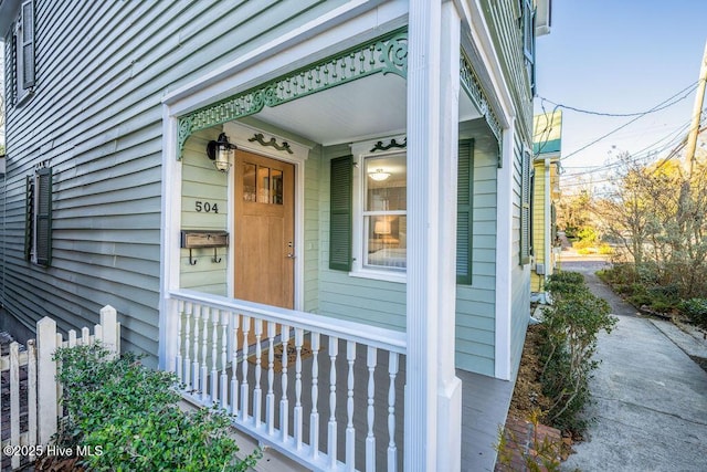 view of exterior entry with covered porch