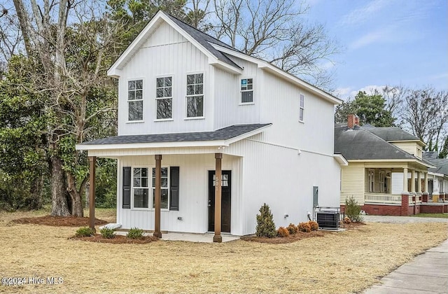 modern farmhouse with central AC unit and covered porch