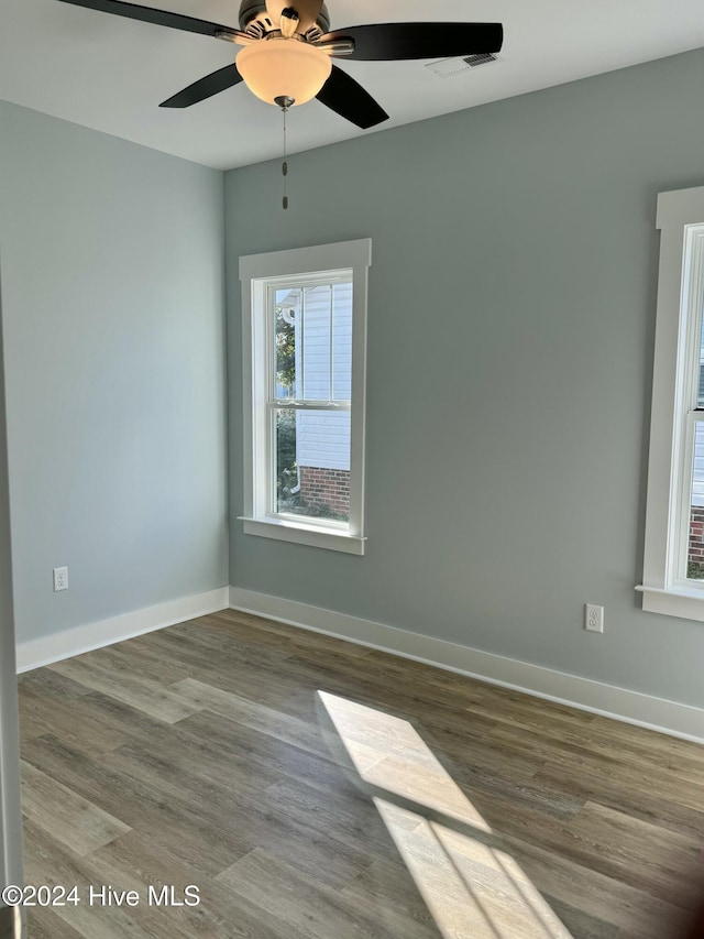 empty room featuring ceiling fan and hardwood / wood-style floors