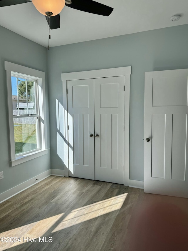 interior space featuring ceiling fan, light hardwood / wood-style floors, and a closet