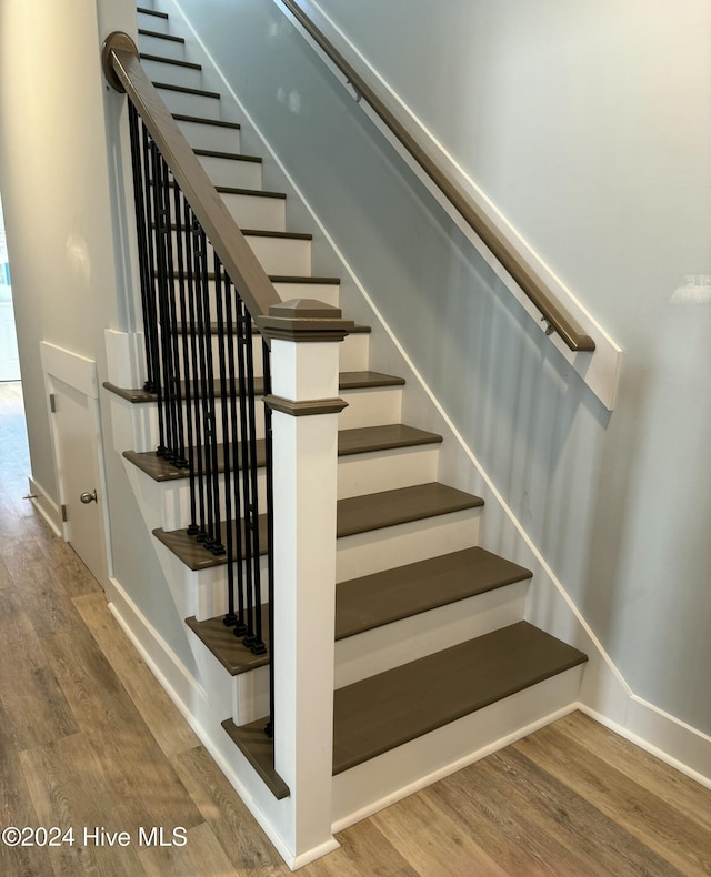 stairway featuring hardwood / wood-style flooring