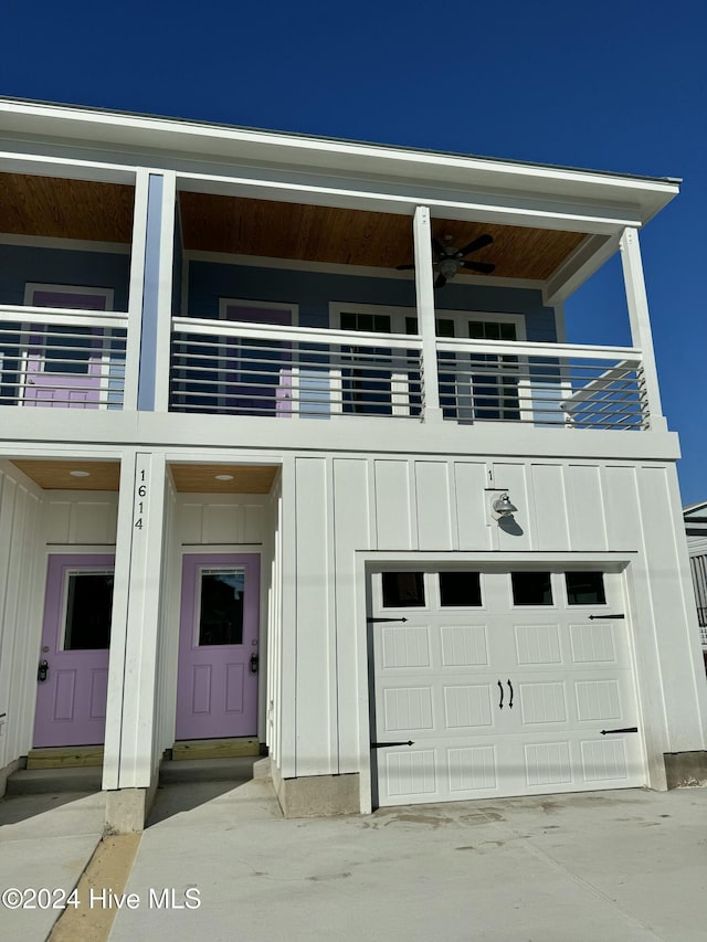 view of front of house with a balcony, a garage, and ceiling fan