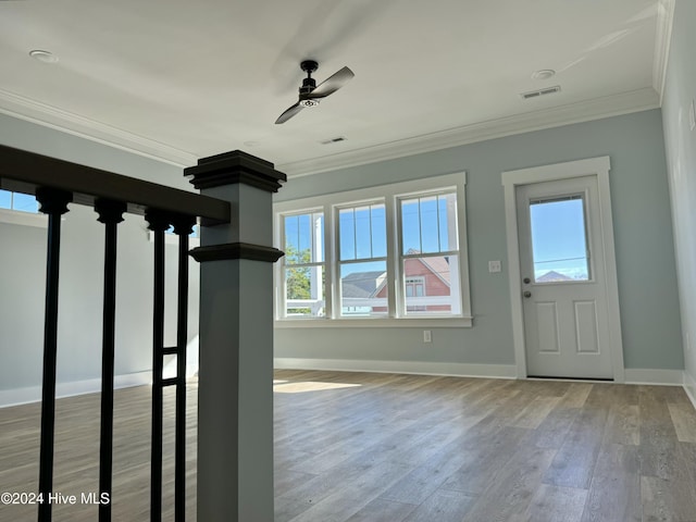 foyer featuring ceiling fan, crown molding, and light wood-type flooring