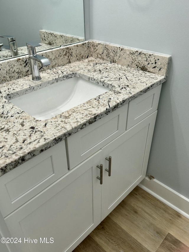 bathroom featuring vanity and hardwood / wood-style flooring