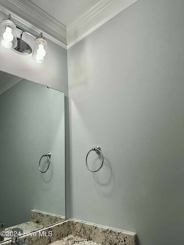 bathroom with vanity and ornamental molding