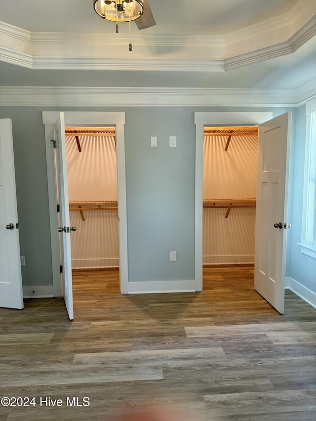 unfurnished bedroom featuring a closet, hardwood / wood-style floors, and a spacious closet