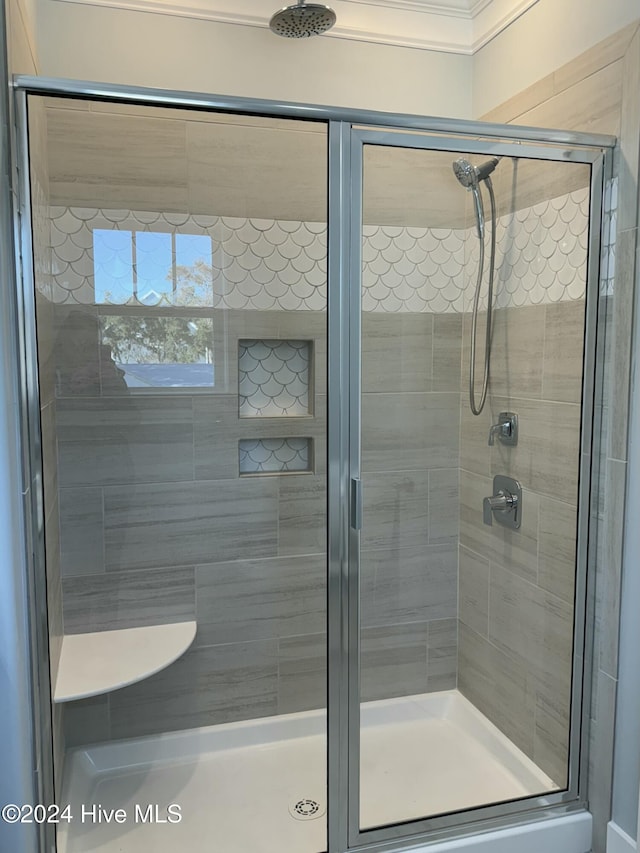 bathroom featuring a shower with shower door