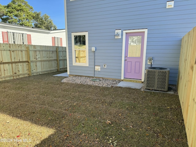 view of exterior entry featuring central air condition unit