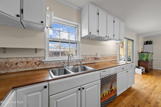 kitchen featuring dishwasher, white cabinets, crown molding, sink, and light wood-type flooring