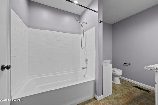 bathroom with bathing tub / shower combination and toilet