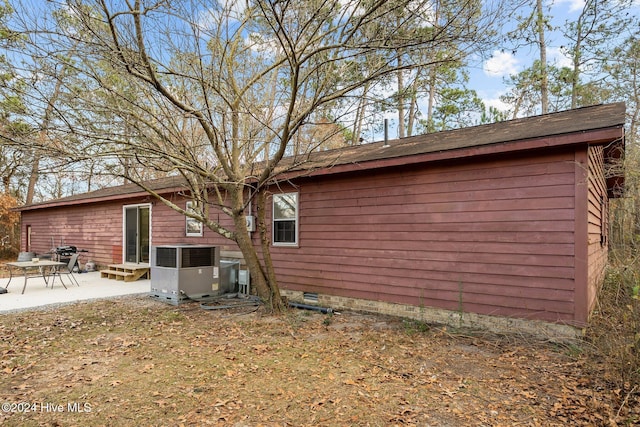 rear view of property featuring central air condition unit and a patio area