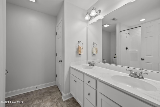 bathroom with vanity, toilet, and walk in shower