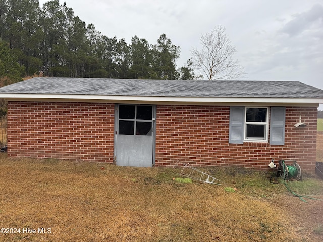 view of side of property with a lawn