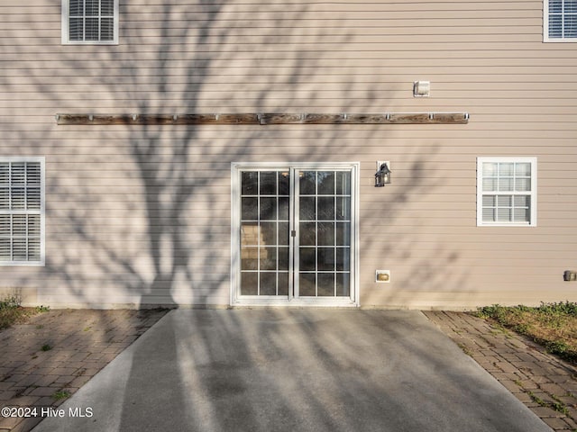 view of exterior entry with a patio