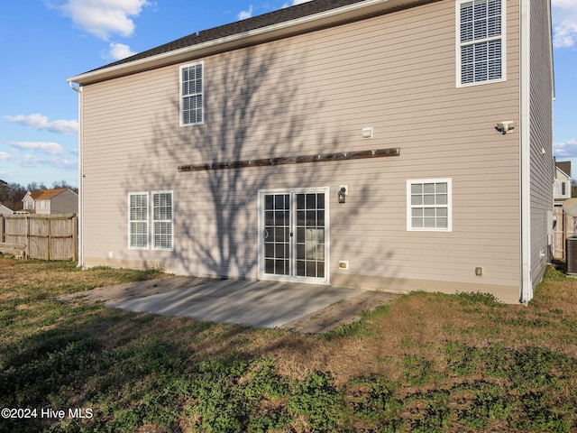 back of property featuring a yard and a patio area