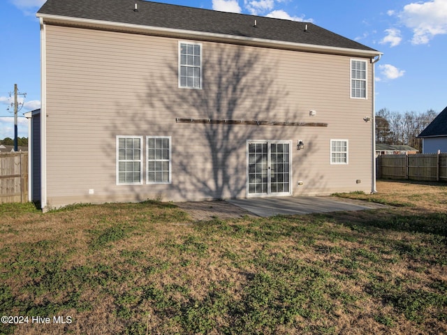 rear view of house with a patio area and a yard