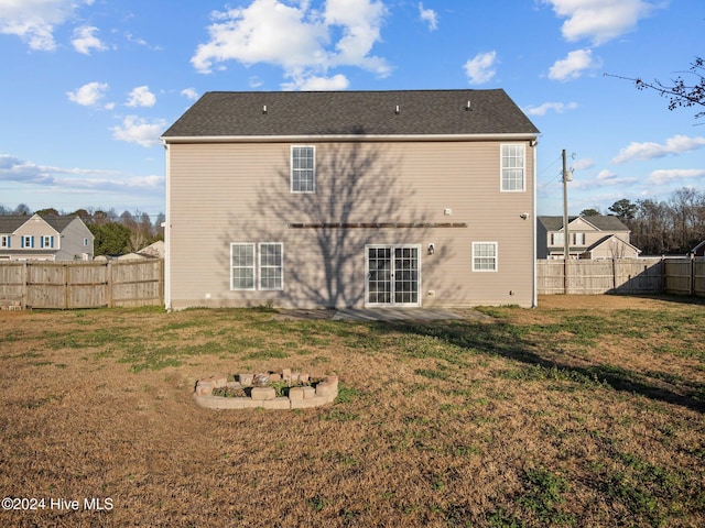 back of property featuring a yard and a patio area