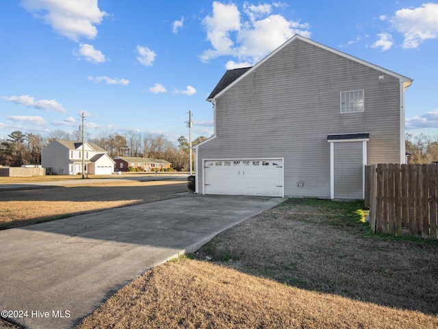 view of property exterior featuring a garage and a yard