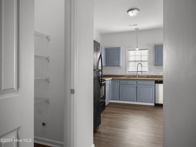 kitchen featuring gray cabinets, sink, stainless steel dishwasher, and decorative light fixtures