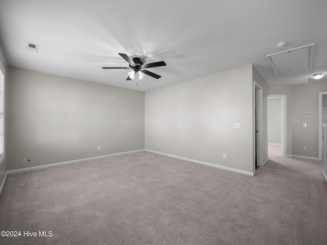 carpeted spare room with ceiling fan