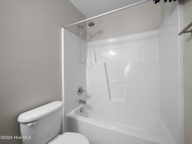 bathroom featuring shower / bathtub combination and toilet