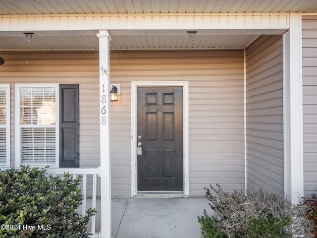 view of exterior entry with a porch