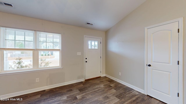 foyer entrance featuring dark wood-type flooring and lofted ceiling