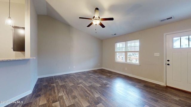 foyer entrance with ceiling fan, a healthy amount of sunlight, dark hardwood / wood-style flooring, and lofted ceiling