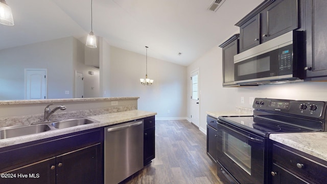 kitchen featuring dark hardwood / wood-style flooring, stainless steel dishwasher, pendant lighting, black range with electric stovetop, and lofted ceiling