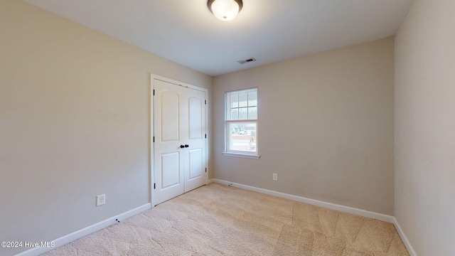 empty room with light colored carpet