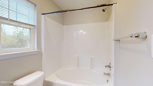 bathroom with shower / bath combination and toilet