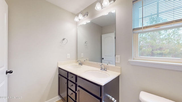 bathroom featuring vanity and toilet