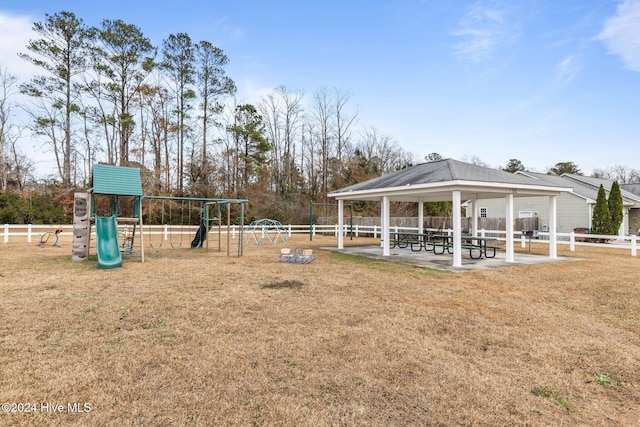 view of home's community featuring a playground and a yard