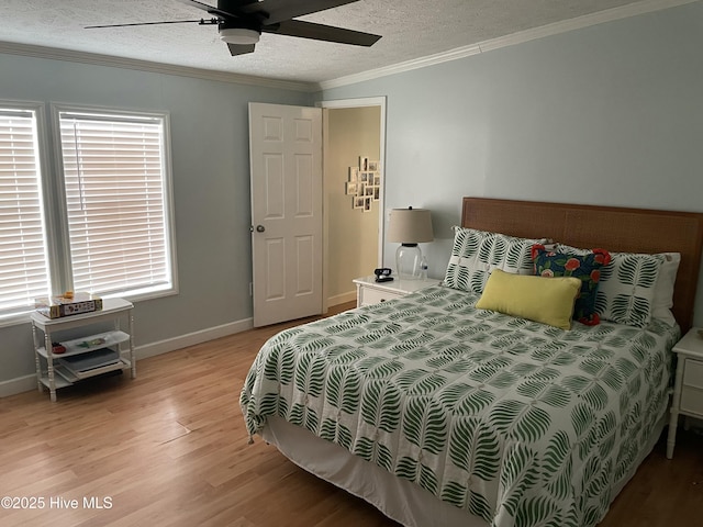 bedroom featuring ceiling fan, light wood-type flooring, a textured ceiling, and ornamental molding