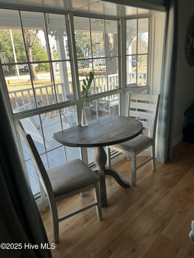 dining area featuring hardwood / wood-style floors and a healthy amount of sunlight