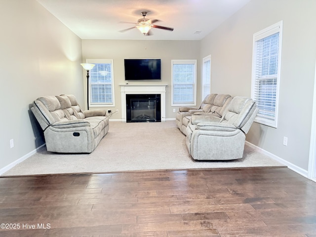 living room with wood-type flooring and ceiling fan