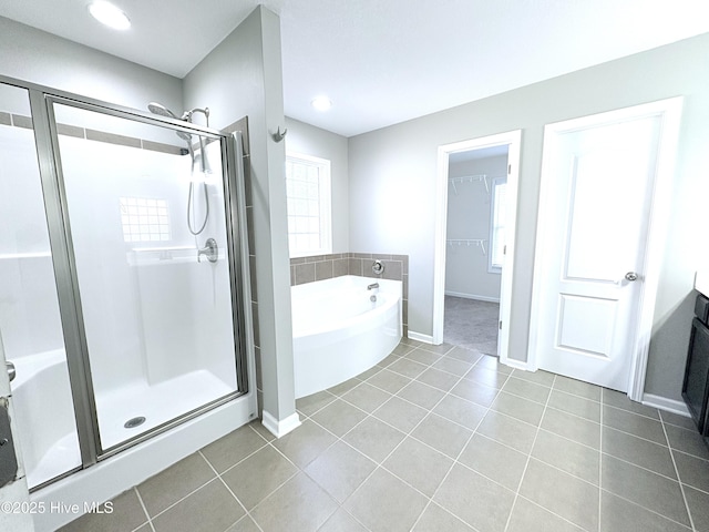 bathroom featuring shower with separate bathtub, vanity, and tile patterned floors