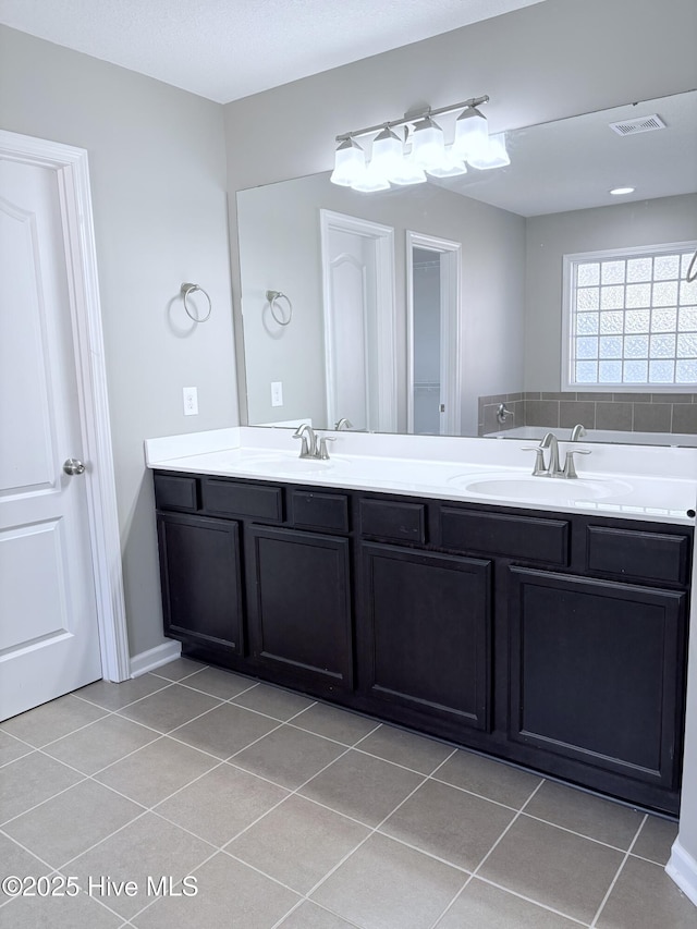 bathroom with tile patterned flooring and vanity