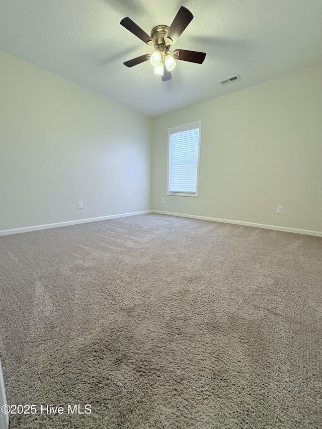 unfurnished room with ceiling fan, carpet floors, and a textured ceiling