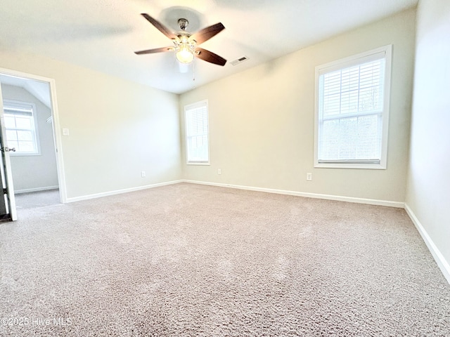 spare room featuring ceiling fan and light carpet